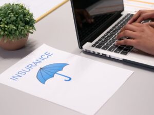A Paper beside a Person Typing on a Laptop - Clear Point Claims
